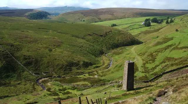 Open moorland on Axe Edge Moor with a small stream crossing the rough grassland under a wide sky