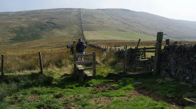 Open gritstone moorland ridge near Shining Tor with a path running along the skyline under a wide sky