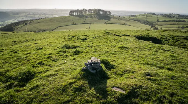 Open hill country in the Staffordshire Moorlands around Musden Low, with fields and a rounded hilltop on the skyline